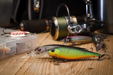 Fishing lures on the background of spinning reels