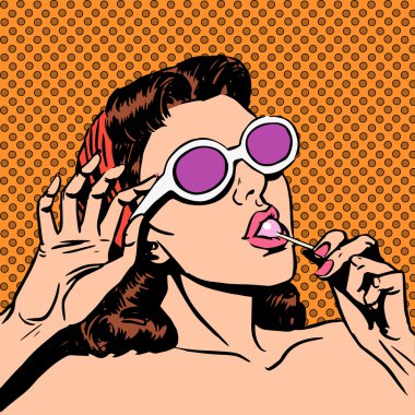 Sunday girl sunbathes on the beach in sunglasses eating a Lollip