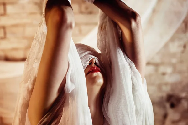 Closeup portrait of a woman with closed by bandage face and red