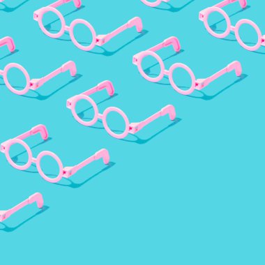 Minimal square crop pattern with pink round glasses frame on serenity pastel blue background. Diagonal copy space.