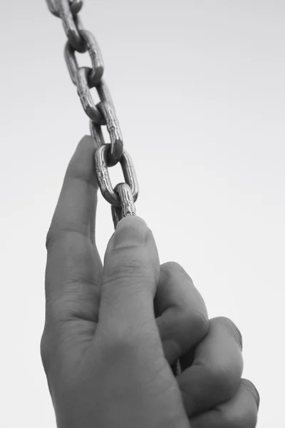 Hand gripping a chain — Stock Photo, Image