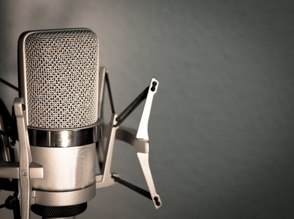 Silver microphone on blue gray background