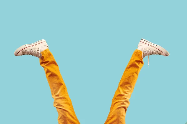 Cropped shot of white footwear, gumshoes on blue studio background — Stock Photo, Image