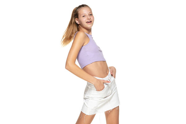 Charming trendy girl looking at camera isolated on white background