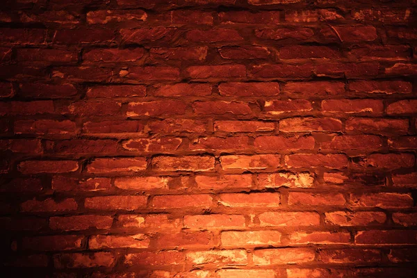 Neon glöd effekt på bränd orange tegelvägg som bakgrund textur — Stockfoto