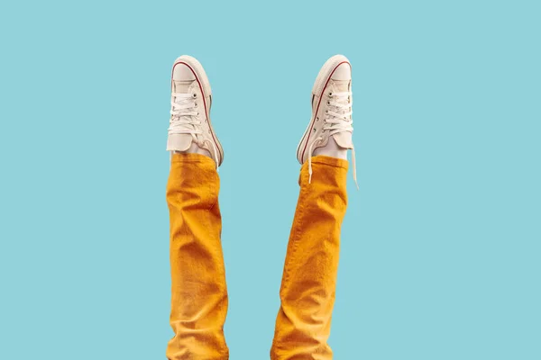 Cropped shot of white footwear, gumshoes on blue studio background — Stock Photo, Image