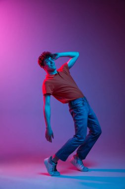 Gündelik giysiler içinde mutlu bir adam neon ışıklarıyla izole edilmiş.