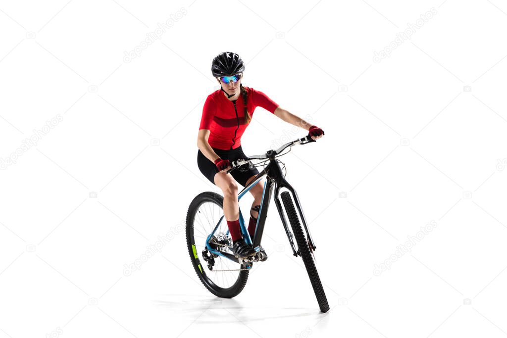 Portrait of young woman bicyclist with road bike isolated over white background.