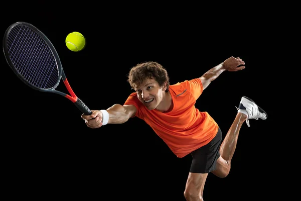 Young Caucasian man, professional tennis player isolated on black background. — Stock Photo, Image