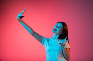 Pembe arka planda izole edilmiş güzel bir kızın portresi.