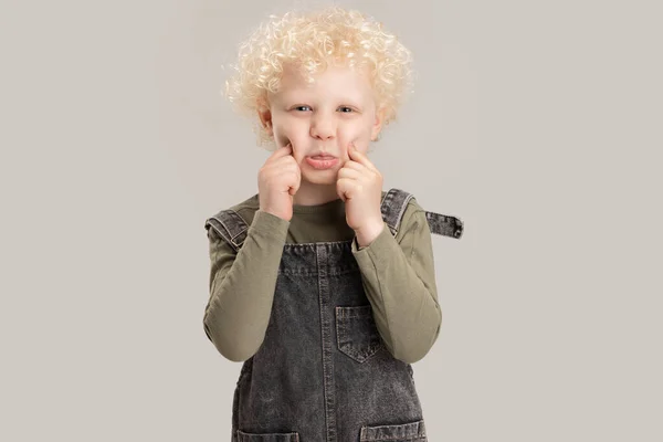 Portrait of little preschool boy posing isolated over gray studio background. — Stock Photo, Image