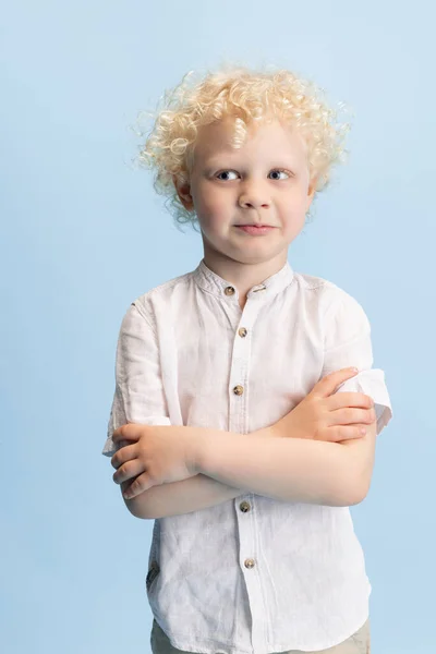 Retrato del niño preescolar posando aislado sobre fondo azul del estudio. — Foto de Stock