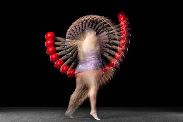 Young girl rhythmic gymnast in motion and action isolated in mixed light on dark background. — Stock Photo, Image
