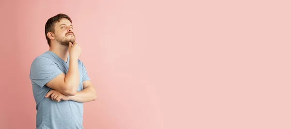 Flyer. Half-length portrait of young Caucasian man isolated on light pink background. — Stock Photo, Image