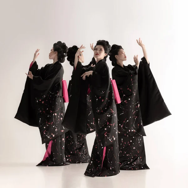 Collage of one young beautiful Japanese, woman in national attire kimono dancing isolated over white background. — Foto de Stock