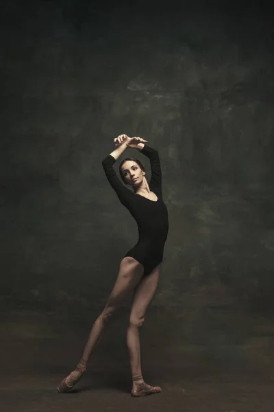 Young and graceful ballet dancer isolated on dark background. Art, motion, action, flexibility, inspiration concept. — Stock Photo, Image