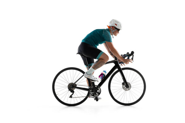 Young professional female bike rider on road bike isolated over white background.