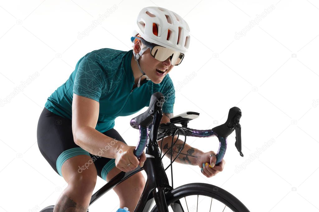 Young professional female bike rider on road bike isolated over white background.