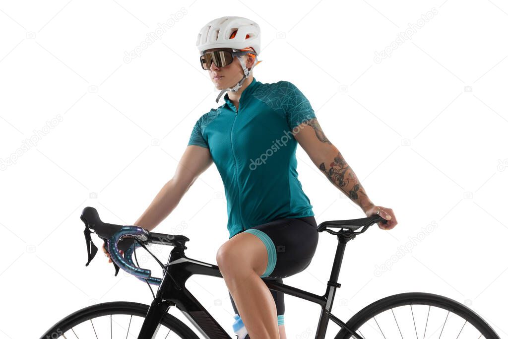 Young professional female bike rider on road bike isolated over white background.