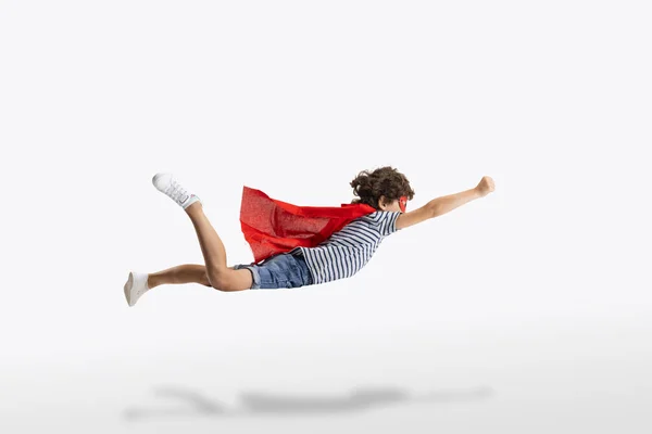 Portrait of little preschool boy in the form of superhero isolated over white studio background. — Stock Photo, Image