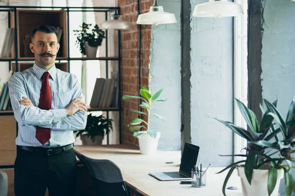 Half-length portrait of young businessman, office worker, manager at office. Concept of business, work days, sales, ad. — Fotografia de Stock