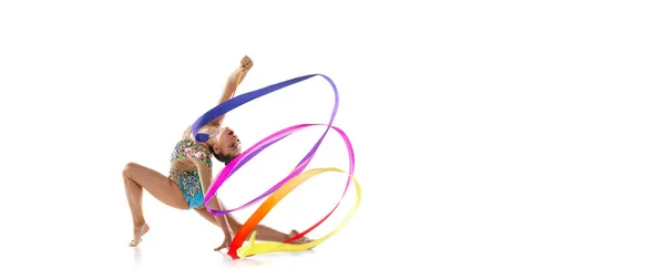 Flyer. One female rhythmic gymnast in motion and action with colorful ribbon isolated over white studio background. — Stock Photo, Image