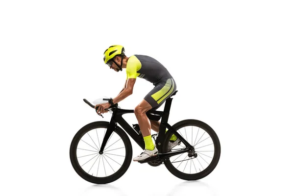 Young professional male bike rider on road bike isolated over white studio background. Side view — Stockfoto