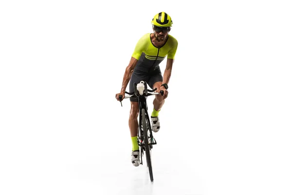 Front view. One young professional bicyclist, man on road bike isolated over white background. — Stockfoto