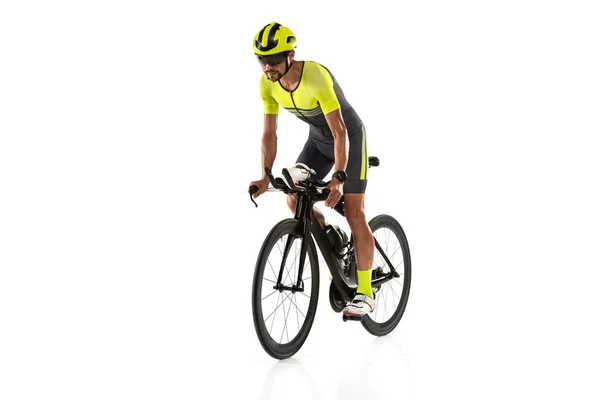 Studio shot of one young professional bicyclist, man on road bike isolated over white background. — Stockfoto