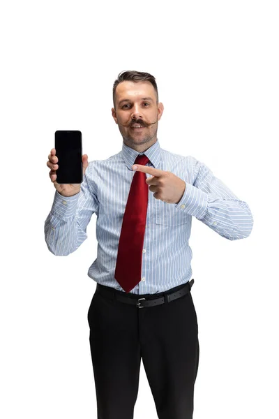 Vertical portrait of young businessman, office worker, manager with smartphone isolated over white studio background. — Stock Photo, Image