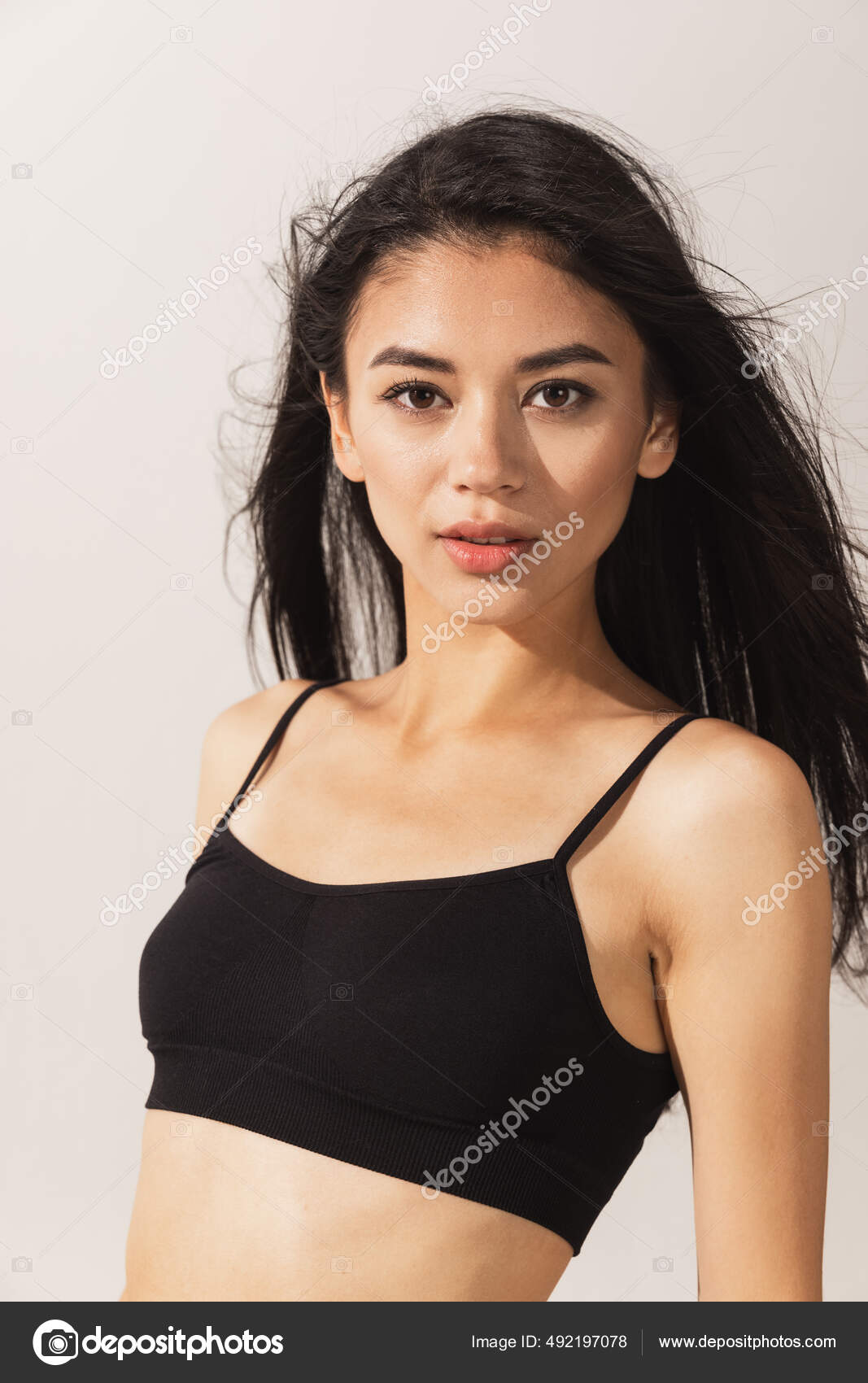 Close-up portrait. Young beautiful Caucasian woman in black underwear  isolated over white studio background. Stock Photo by ©LustreArt 492197078