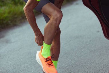 Genç profesyonel erkek triatlet, açık yolda koşan koşucu. Spor, yaşam tarzı, hareket ve eylem kavramı