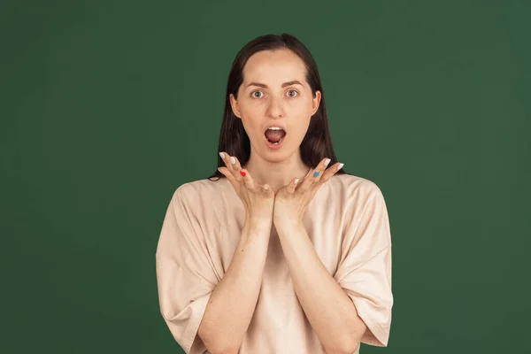 Portrait of young Caucasian woman posing isolated on green background. — Stock Photo, Image