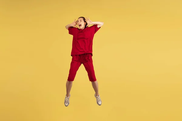 Portrait of young Caucasian woman jumping isolated on yellow background. — Stock Photo, Image