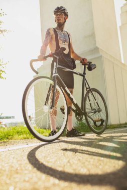 Yaz günü bisiklet süren genç bir bisikletçi. Hareket, hareket konsepti