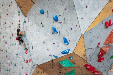 Tırmanma ekipmanlarıyla dışarıda taş duvarda pratik yapan sevimli bir genç kız. Küçük yürüyüşçü. Etkin yaşam tarzı kavramı