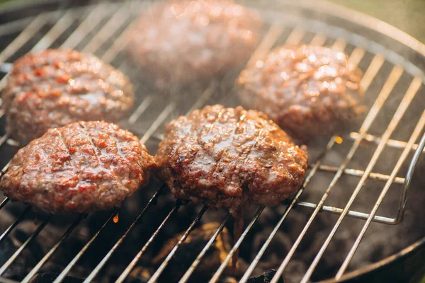 Foto de close-up de costeletas de hambúrguer na grelha. Comida saborosa — Fotografia de Stock