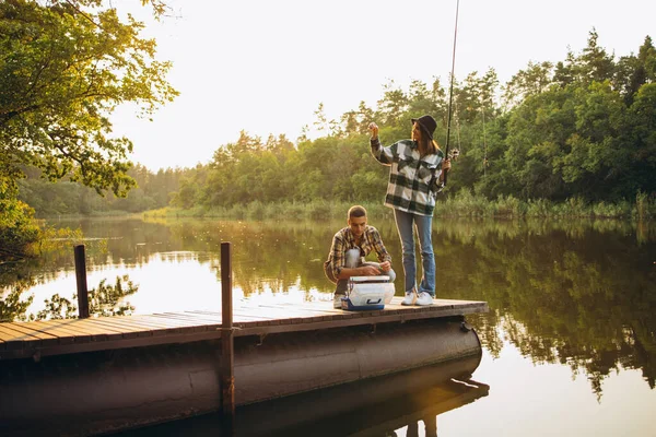 日没の田舎で暖かい夏の日に若い夫婦釣りの肖像画。ロマンチックな日 — ストック写真