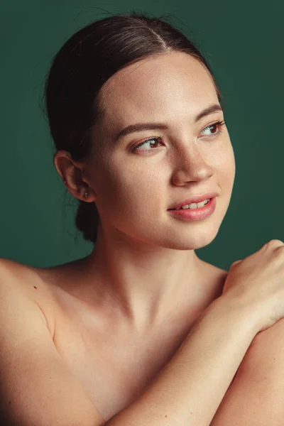 Close-up portret van jong mooi meisje weg te kijken geïsoleerd over groene achtergrond — Stockfoto