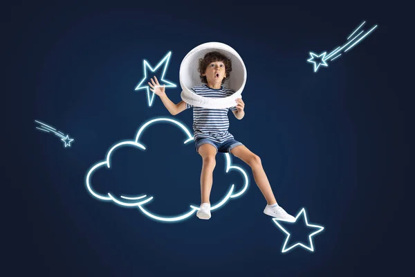 Creative artwork of little boy pretending to be astronaut isolated over dark blue background with white space drawings. — Stock Photo, Image