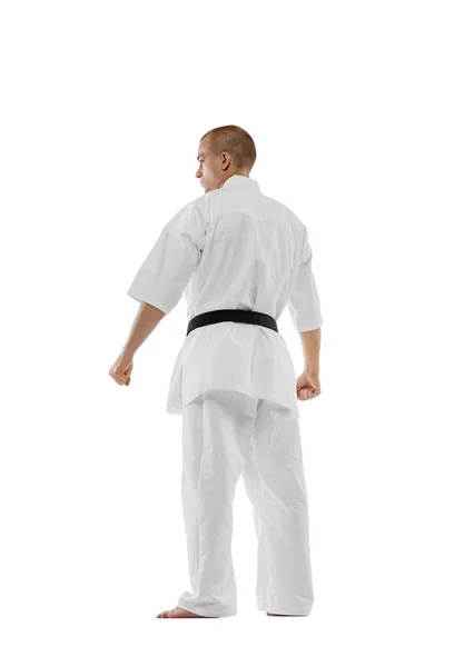 Tillbaka visa porträtt av professionell karateka i kimono med svart belth isolerad över vit bakgrund. Karate, judo, taekwondo sport — Stockfoto