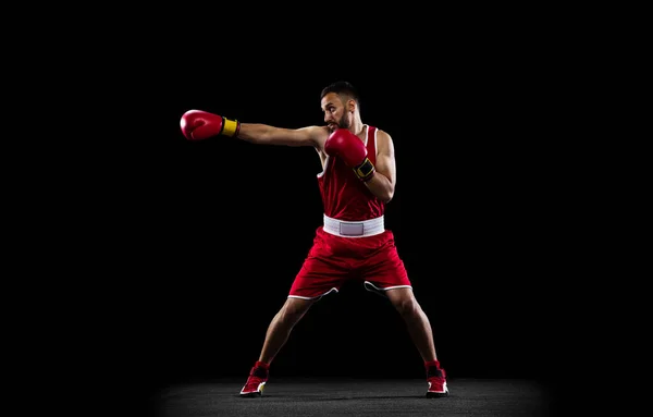 黒の背景に隔離された赤の均一な訓練の1つのプロボクサーの完全な長さの肖像画 パンチの動きだ 選手権 スポーツ 運動の概念 広告のコピースペース — ストック写真