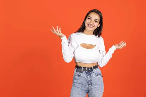 Portrait of beautiful caucasian girl in fashionable clothes posing isolated over orange background. Happiness and joy — Stock Photo, Image