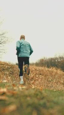 Athletic runners climbing hill during trail workout. Concept of performance footwear promotion, off-road running gear marketing, endurance training visuals, outdoor sport branding.