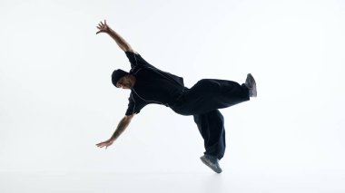 Professional breakdancer performing inverted power move isolated. Concept of high level street dance technique, body control, determination, and physical excellence.