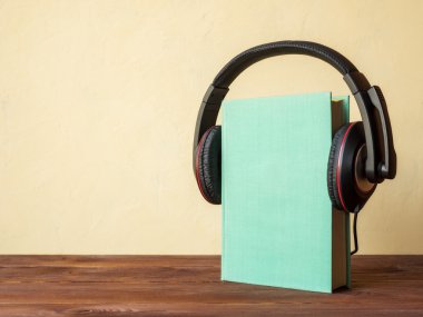Book on the table with headphones clipart