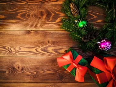 Çelenk ahşap tahta üzerinde. Hediye kutuları sarılmış. Noel ve yeni yıl kavramı