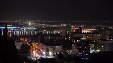 Yukarıdan ateş ediyorlar. Gece şehri. Işıklı. Komşuların pencereleri..