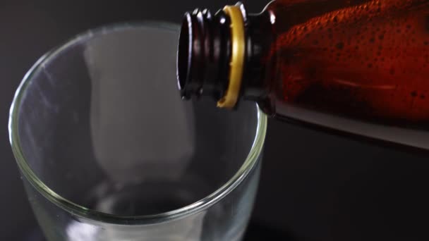 Beer from a plastic bottle is poured into a glass. — Stock Video