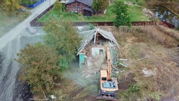 Demolition of buildings. an excavator breaks down old village house. — Stock Video